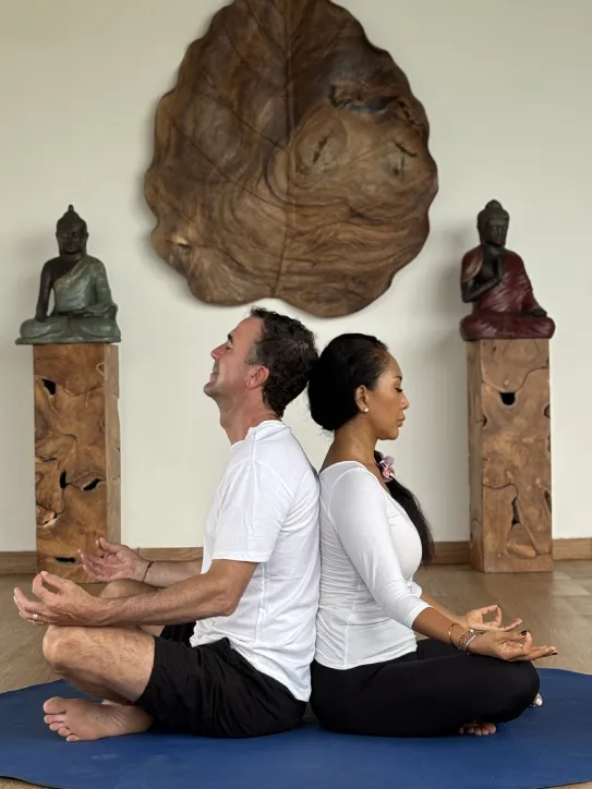 Couple practicing meditation together in a peaceful setting