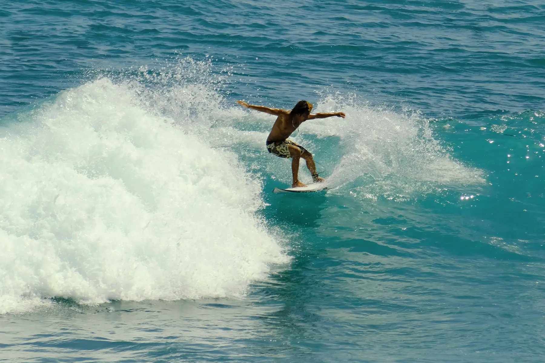 Surfer riding a big wave on a sunny day at the beach