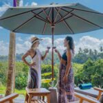A serene setting showcasing a luxury villa surrounded by lush greenery, inviting guests to relax and enjoy a tranquil getaway in Bali