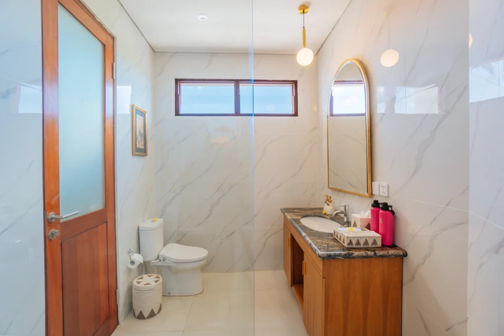 clean toilet with mirror at the bodhi leaf bali