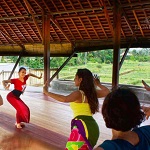 Students participating in a Balinese dance lesson, learning traditional movements and cultural expressions