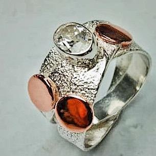 A skilled silversmith at work, crafting intricate jewelry pieces using traditional techniques and tools