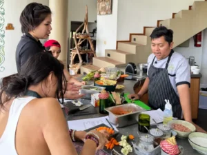 Participants learning to cook dishes with fresh ingredients.