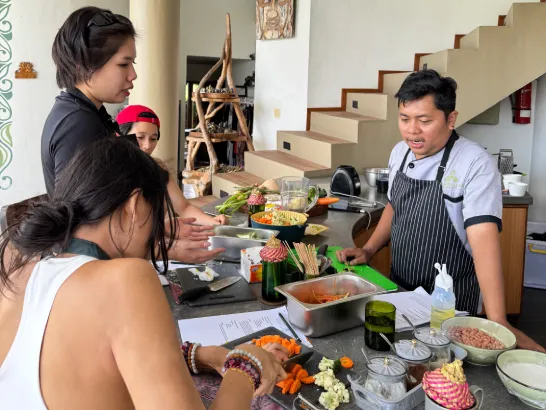 Participants learning to cook dishes with fresh ingredients.
