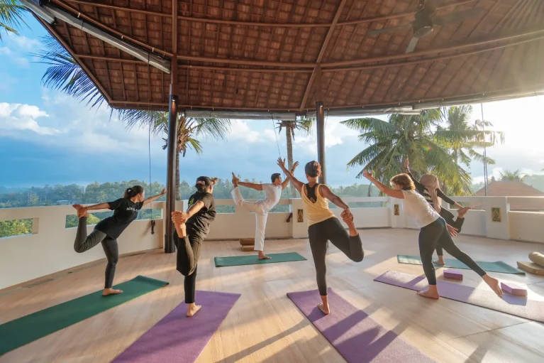 yoga group session in the morning at the yoga shala with a beautiful nature view