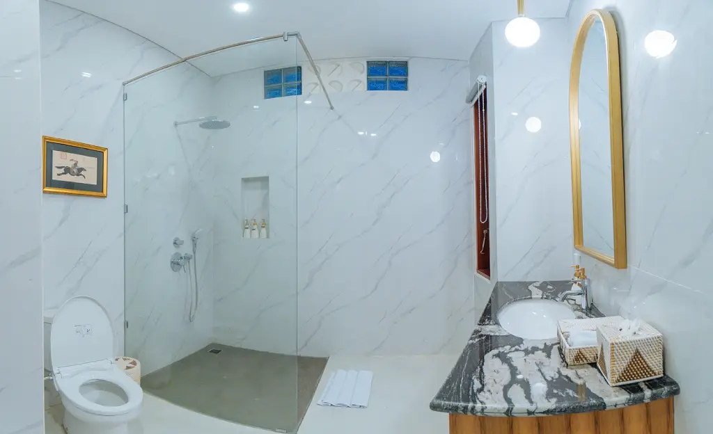 A serene and well-designed bathroom at The Bodhi Leaf Wellness, featuring modern fixtures and a relaxing atmosphere