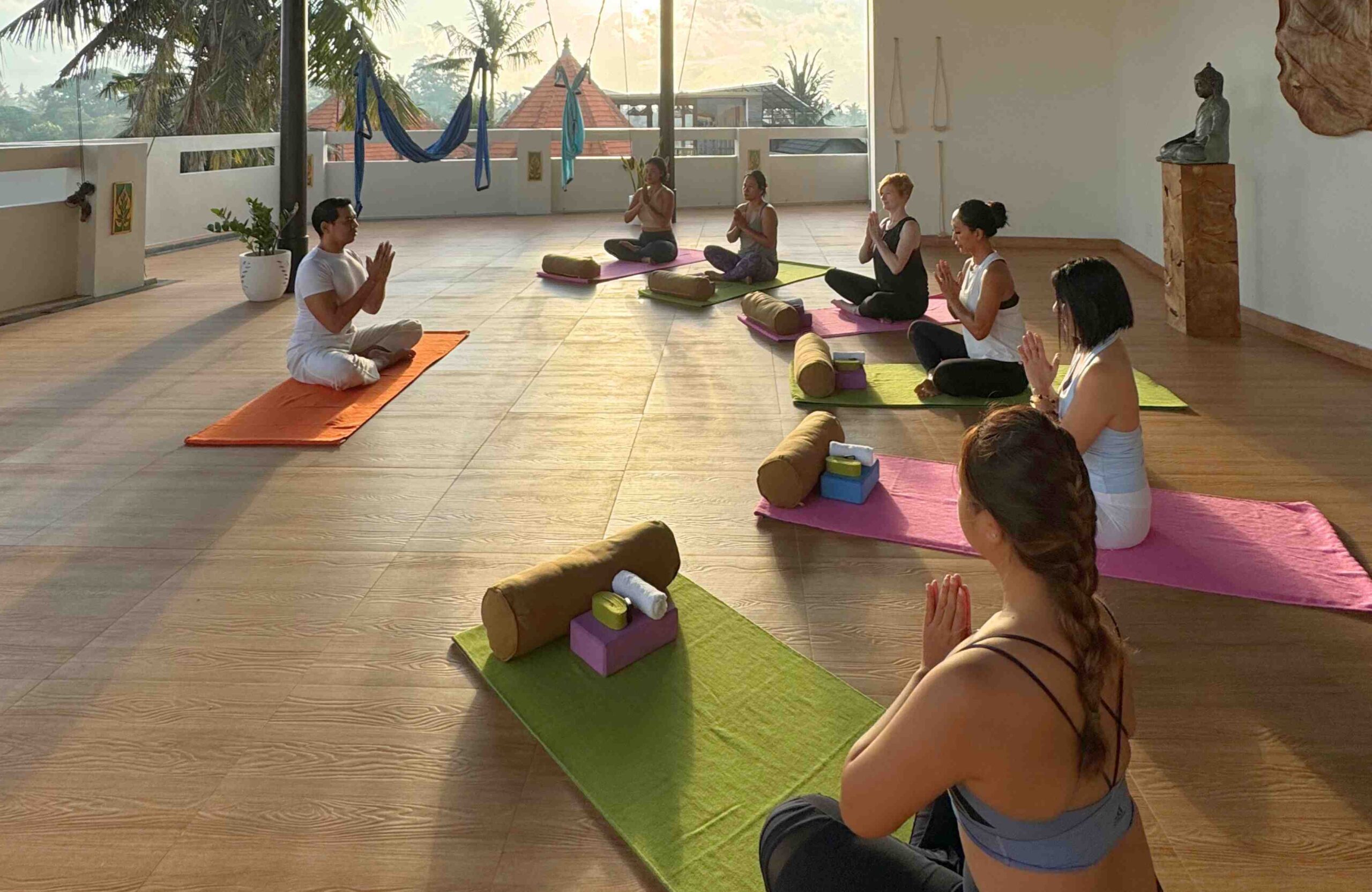 participants dong yoga session in a serene yoga shala at the evening