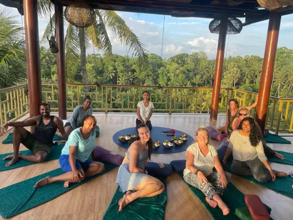Participants experiencing a sound healing class with various instruments for relaxation