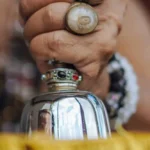 A traditional bell ringing during a worship ceremony, emitting a peaceful, resonant tone