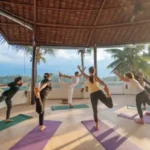 yoga group session in the morning at the yoga shala with a beautiful nature view