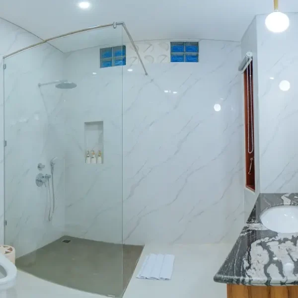 A serene and well-designed bathroom at The Bodhi Leaf Wellness, featuring modern fixtures and a relaxing atmosphere