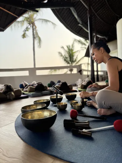 Person relaxing during a sound healing session with singing bowls.