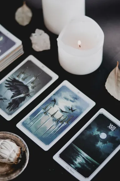 A beautifully illustrated tarot card displaying symbolic imagery and intricate details