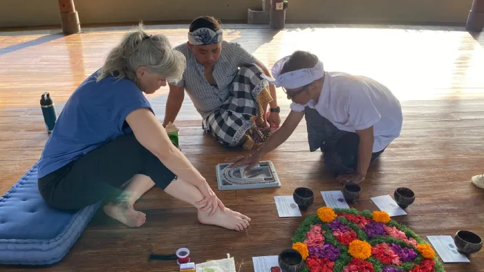 Participants creating mala during a workshop at The Bodhi Leaf, surrounded by serene decor