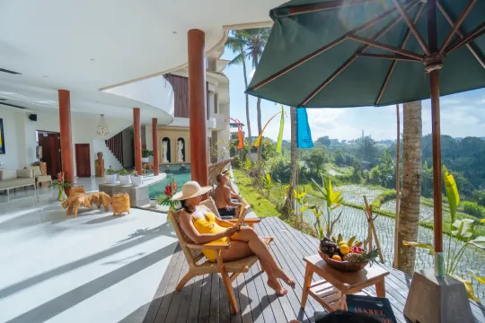 relax couple by the pool looking at ricefield and nature scenery