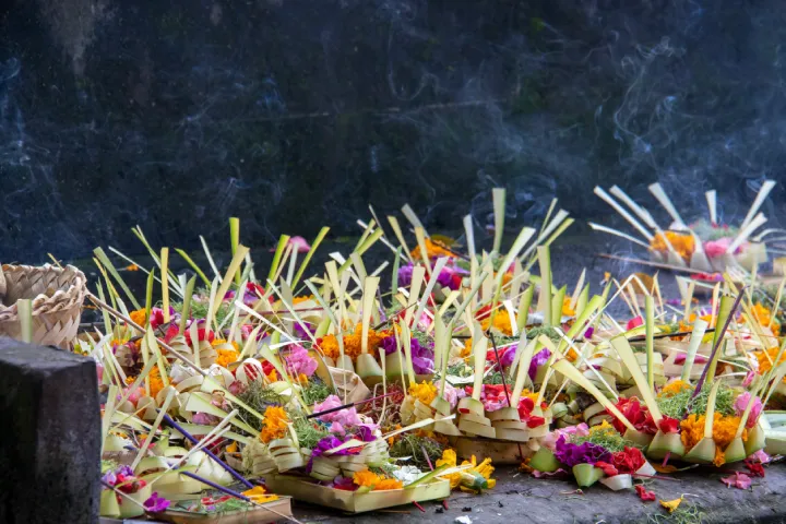Balinese Canang Sari offering made of flowers and palm leaves.