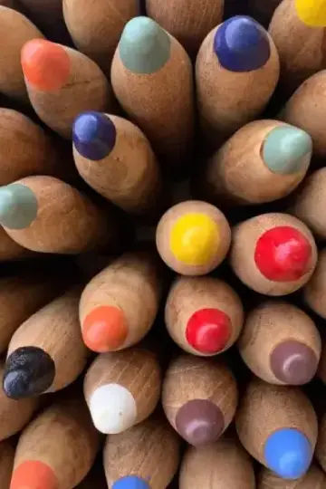 A set of colored pencils neatly arranged, displaying a variety of vibrant hues