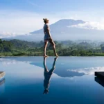 Peaceful infinity pool view over green mountains and rice terraces